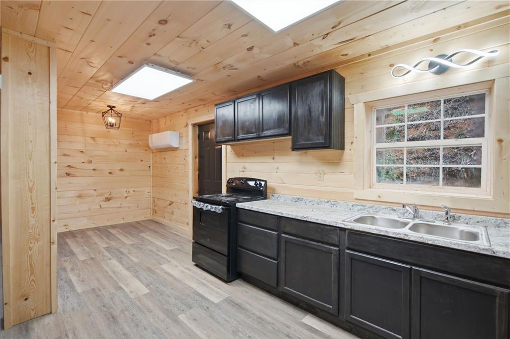 1780 Conasauga Road Ellijay, GA 30540 - Photo 8 of 43 a kitchen with stainless steel appliances granite countertop a sink stove and cabinets