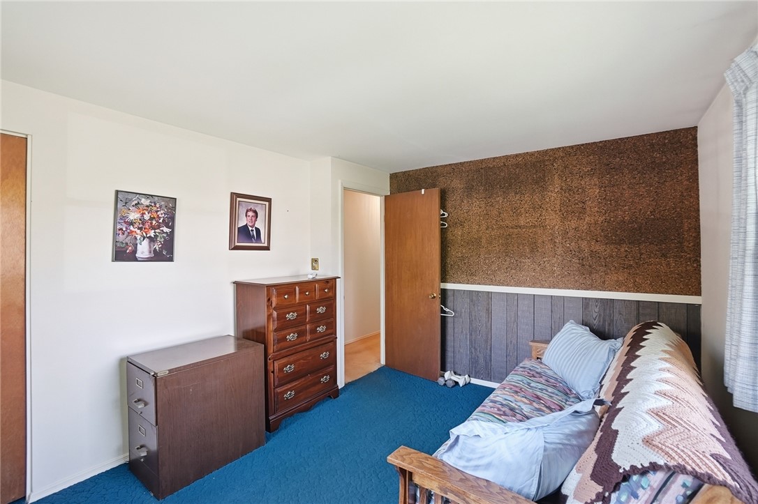 6225 Possum Run Road Bellbrook, OH 45305 - Photo 23 of 33 This cozy bedroom features a bold blue carpet and unique wall textures, creating a comfortable retreat.