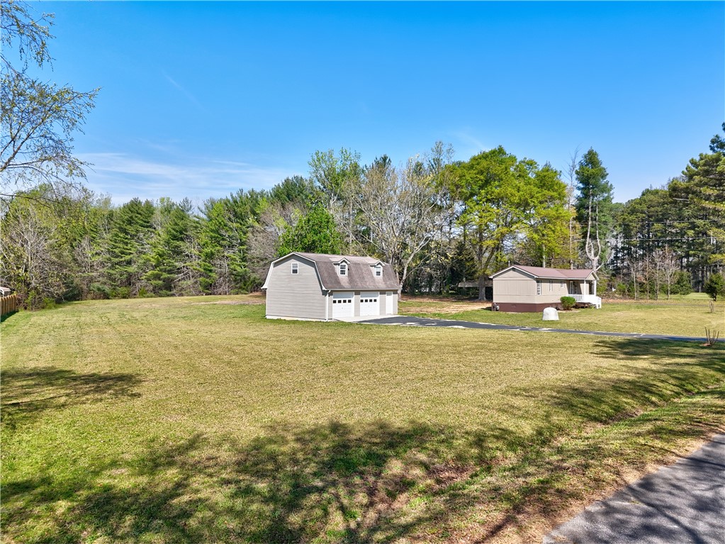 220 Bill Kay Road Belton, SC 29627 - Photo 20 of 30 Expansive green grounds surround a charming residence and separate garage.