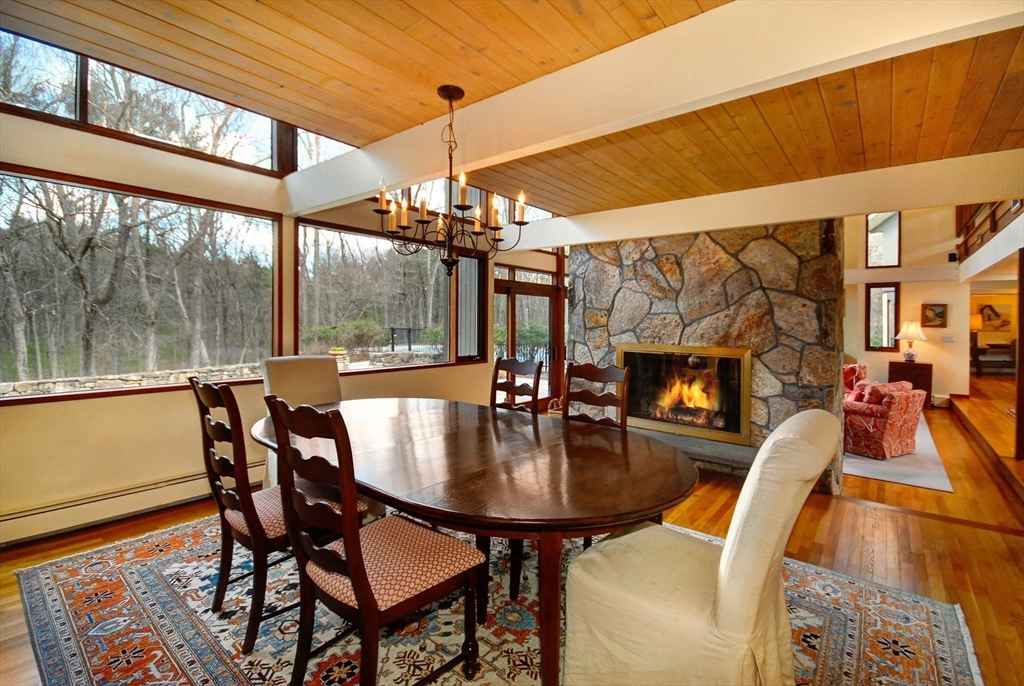 968 Lowell Road Concord, MA 01742 - Photo 10 of 39 a dining room with furniture a fireplace and wooden floor