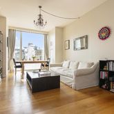 a living room with furniture and a book shelf