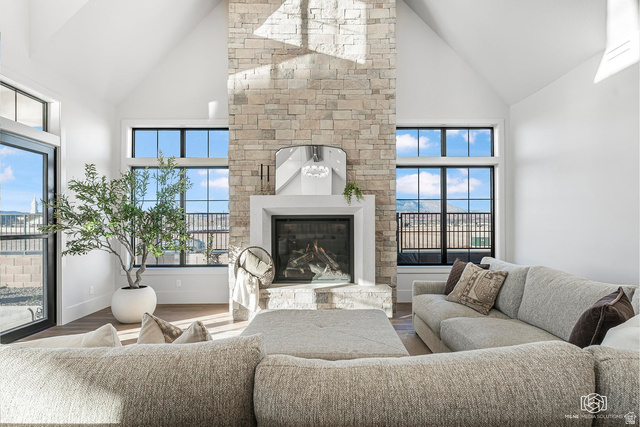 1468 South Red Cliffs Temple Lane St. George, UT 84790 - Photo 13 of 64 Living room featuring a glass covered fireplace, wood finished floors, and lofted ceiling