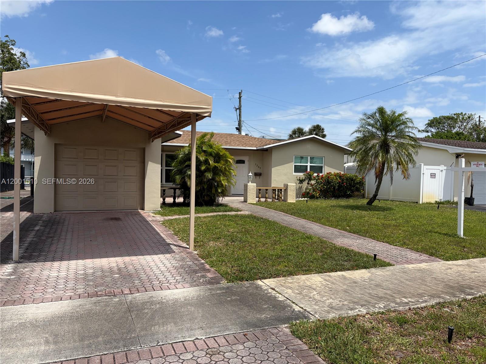 3205 Liberty Street Hollywood, FL 33021 - Photo 2 of 12 a front view of house with yard