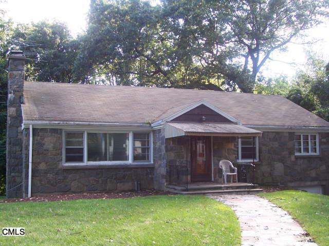 408 Holland Road Bridgeport, CT 06610 - Photo 1 of 1 a front view of a house with a yard