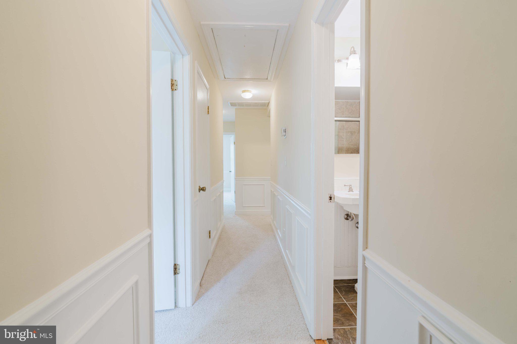 10200 Duvawn Place Silver Spring, MD 20902 - Photo 16 of 42 Inviting hallway with soft lighting.