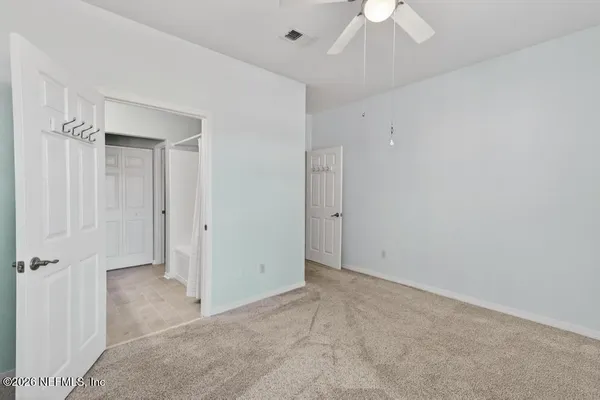 an empty room with a empty space and chandelier fan