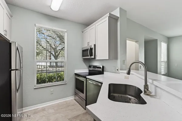 a view of a hallway with wooden shelves