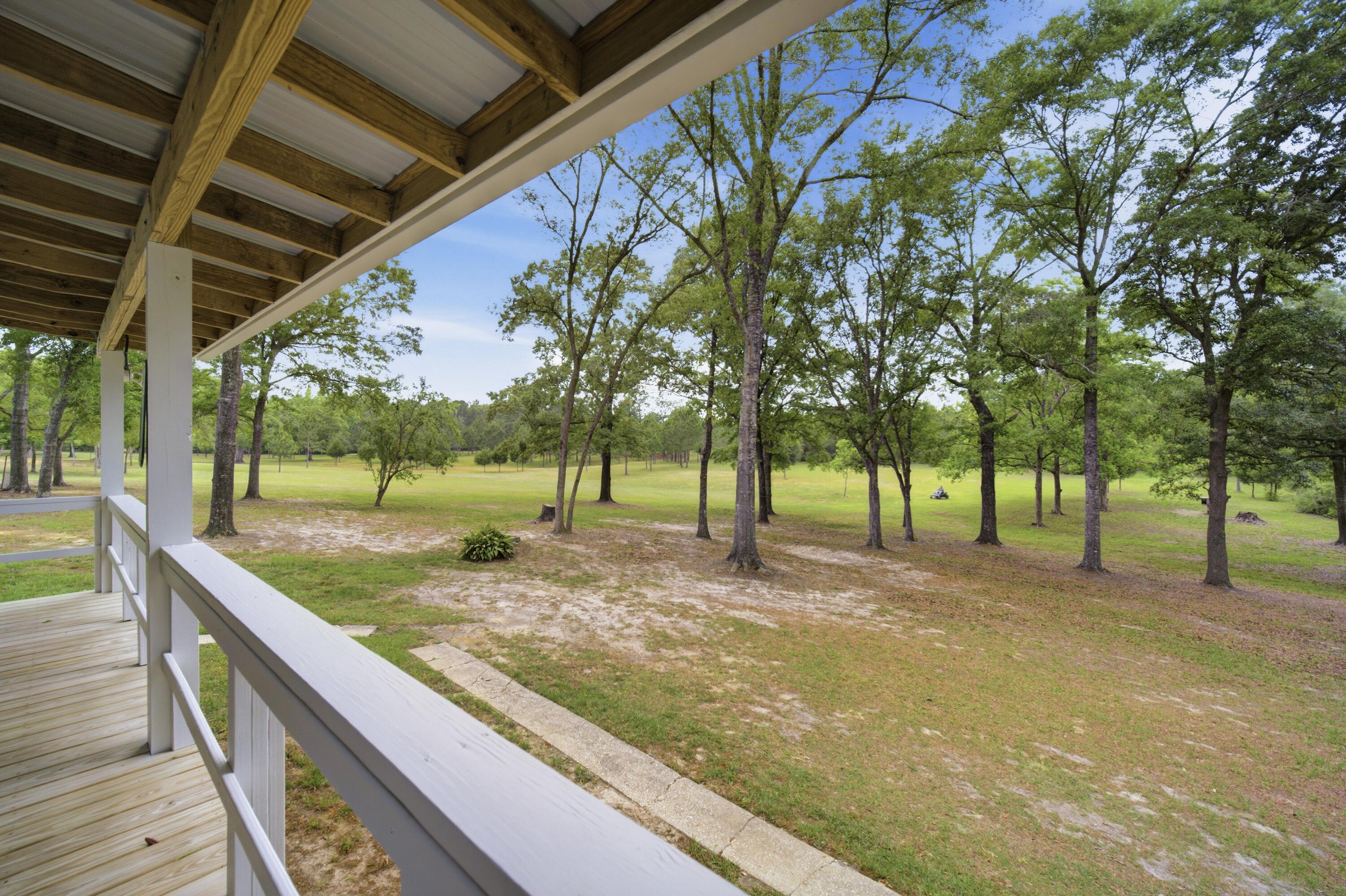 261 Wilkerson Road DeFuniak Springs, FL 32433 - Photo 66 of 76 a view of a backyard with tree