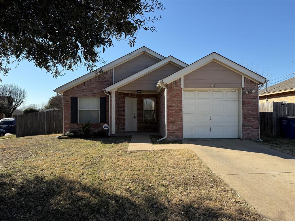 487 Pleasant Meadows Lane Dallas, TX 75217 - Photo 1 of 18 a front view of a house with yard and garage