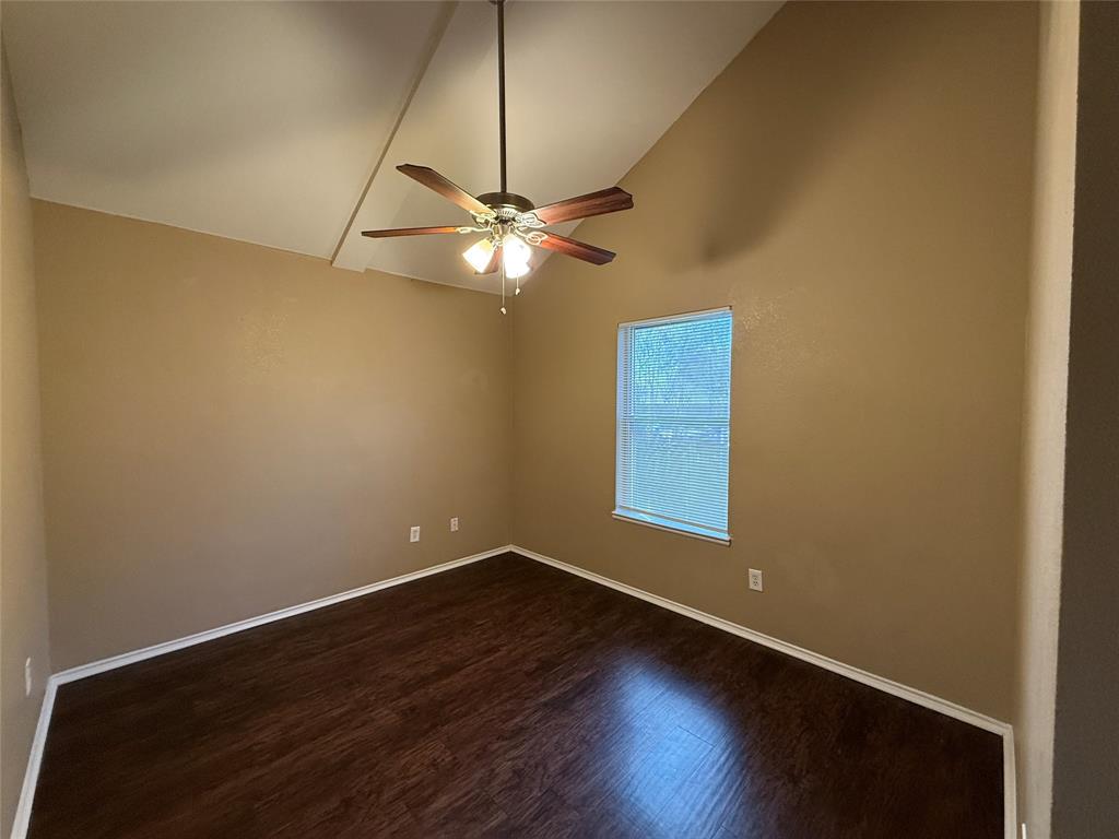 487 Pleasant Meadows Lane Dallas, TX 75217 - Photo 12 of 18 an empty room with wooden floor and windows