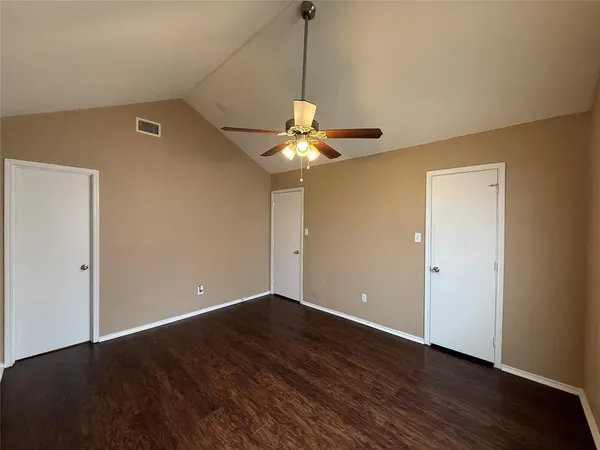 a view of a room with wooden floor chandelier and a window