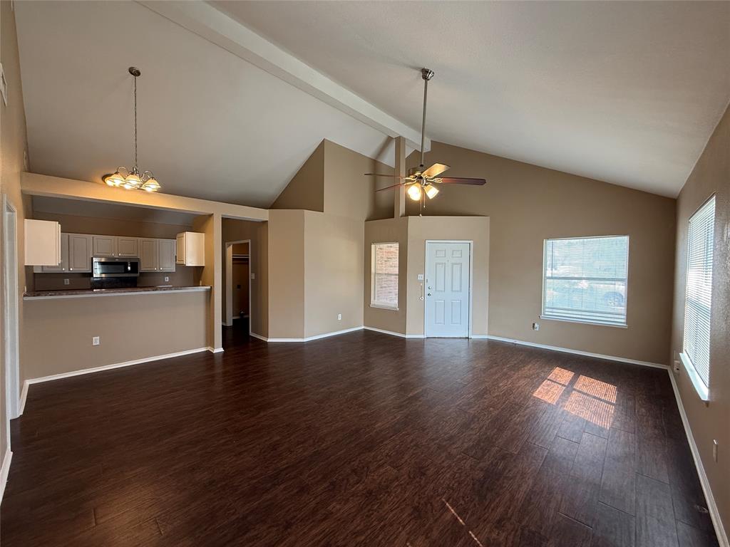 487 Pleasant Meadows Lane Dallas, TX 75217 - Photo 5 of 18 a view of an empty room with window and wooden floor