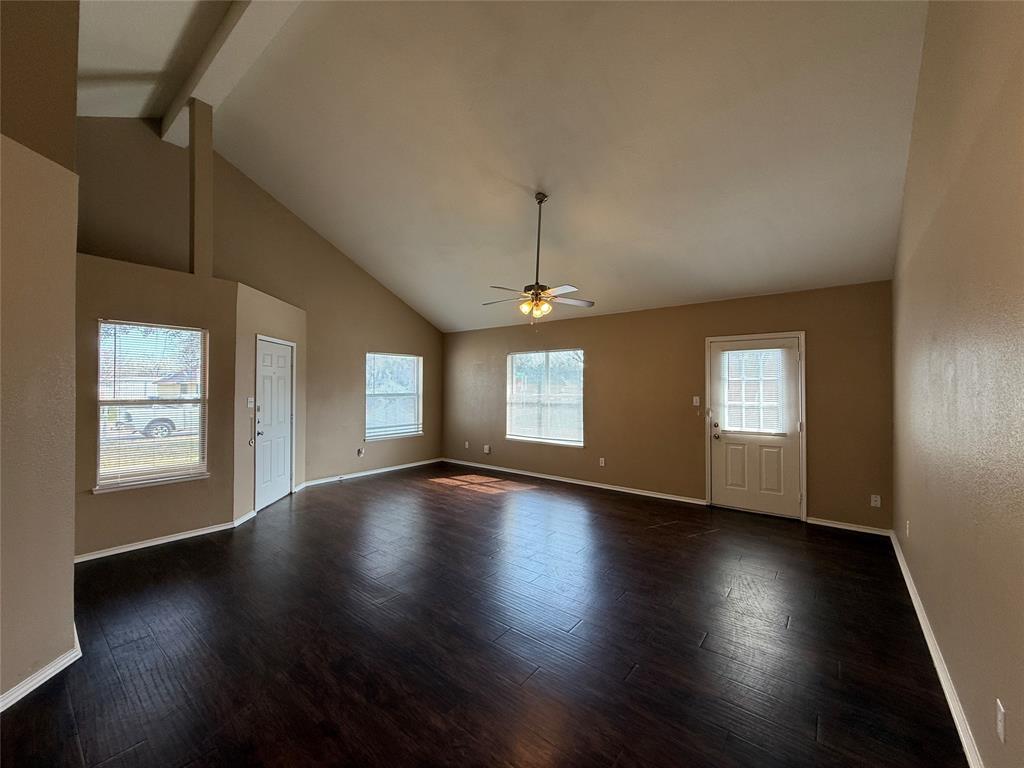 487 Pleasant Meadows Lane Dallas, TX 75217 - Photo 6 of 18 an empty room with wooden floor and windows