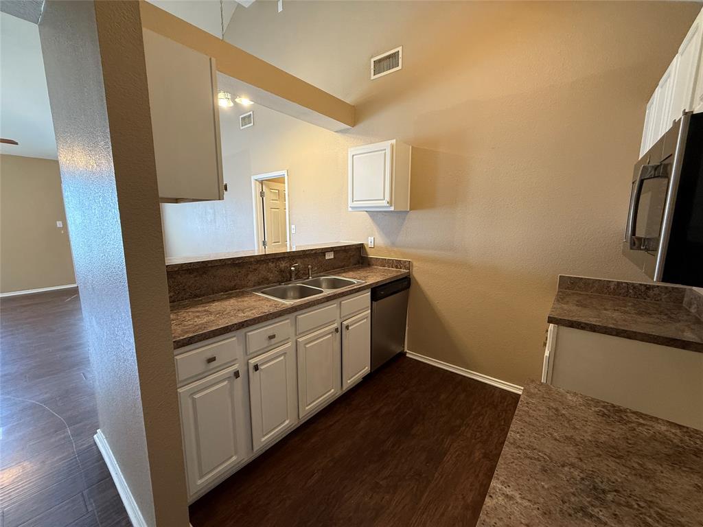 487 Pleasant Meadows Lane Dallas, TX 75217 - Photo 7 of 18 a kitchen with granite countertop a sink and a stove top oven