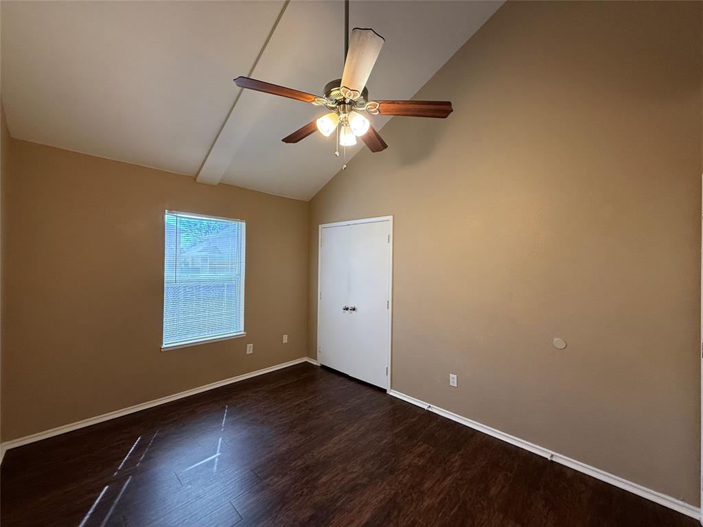 487 Pleasant Meadows Lane Dallas, TX 75217 - Photo 10 of 18 an empty room with a window and a ceiling fan