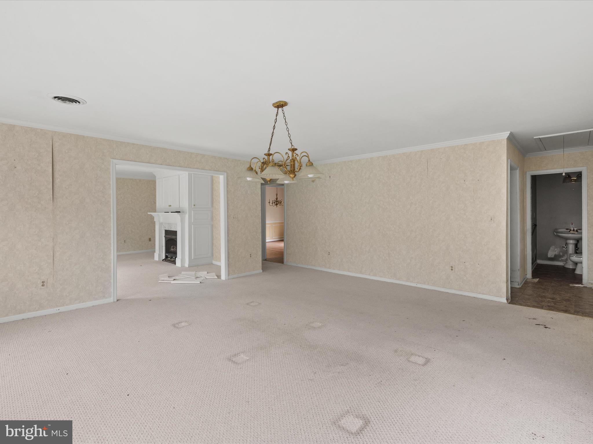 935 Susquehanna Road Madison, MD 21648 - Photo 11 of 42 an empty room with chandelier fan and windows