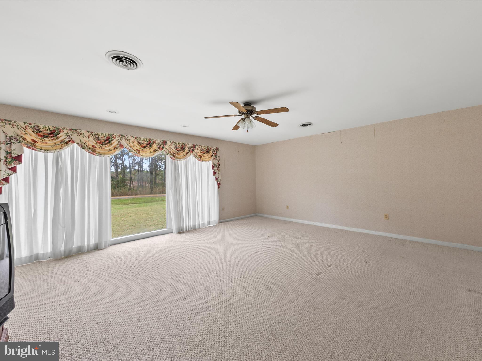 935 Susquehanna Road Madison, MD 21648 - Photo 15 of 42 a view of a room with a ceiling fan and a window