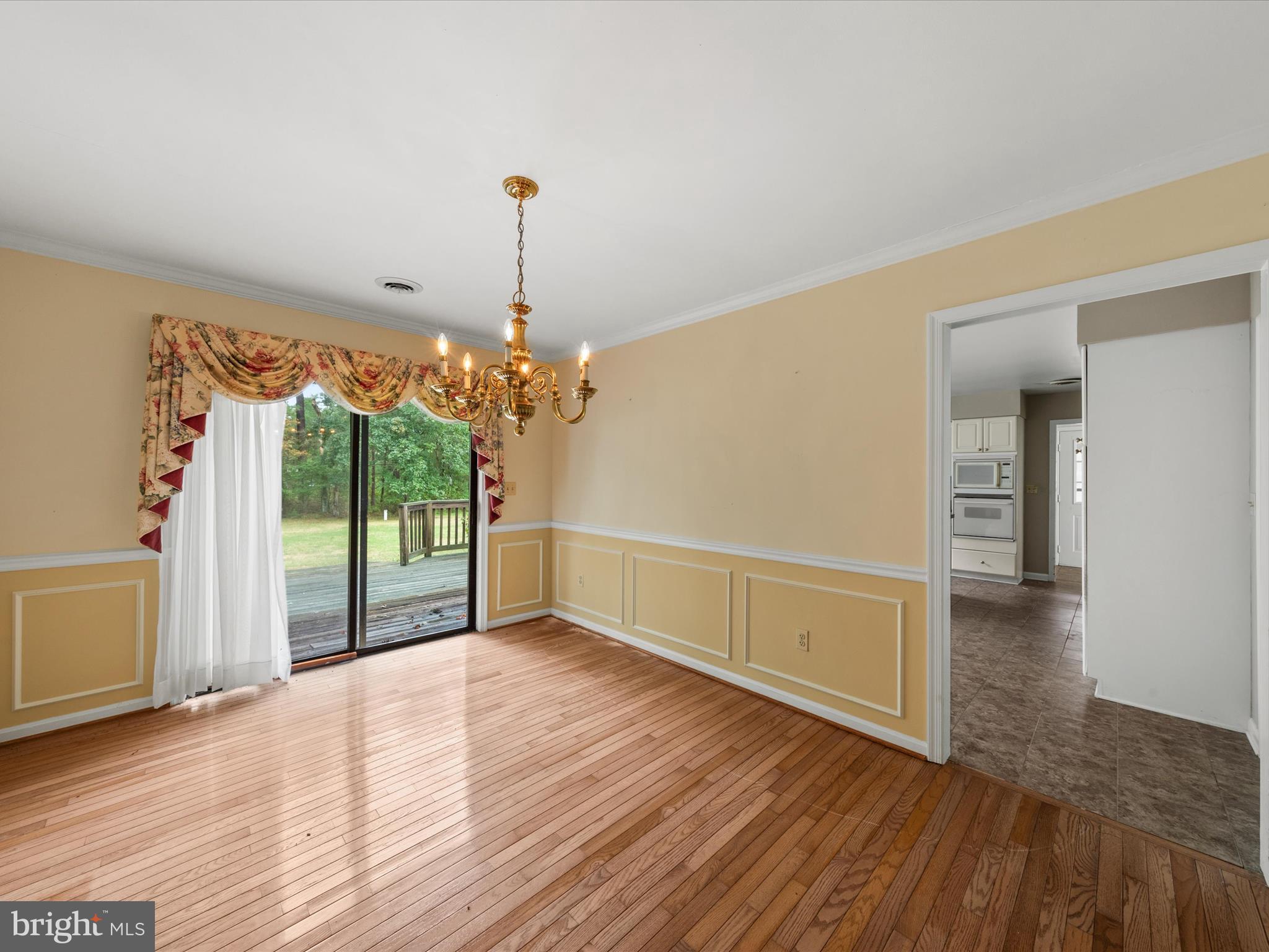 935 Susquehanna Road Madison, MD 21648 - Photo 27 of 42 a view of an empty room with wooden floor and a window