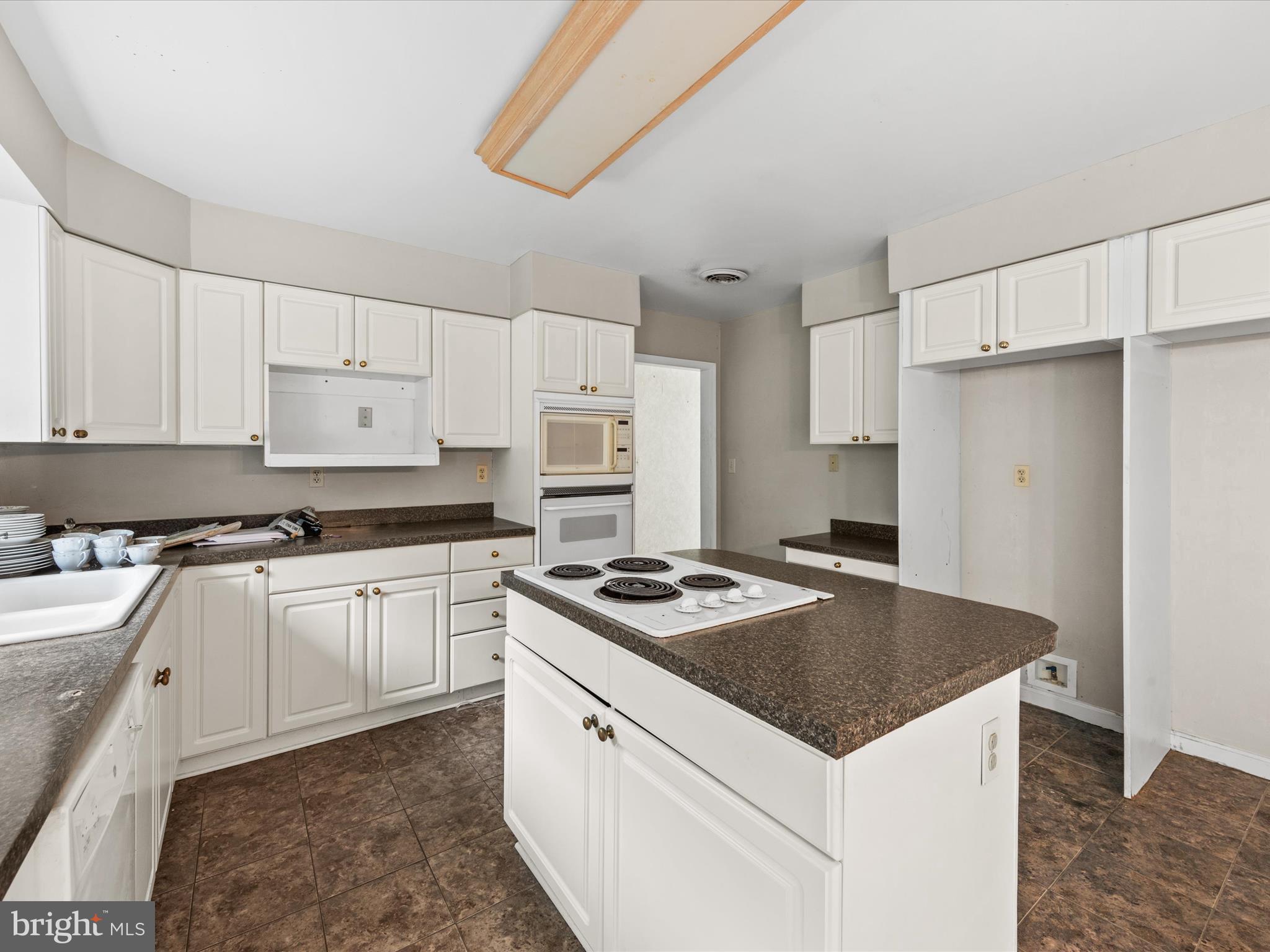 935 Susquehanna Road Madison, MD 21648 - Photo 35 of 42 a kitchen with granite countertop a sink stove and refrigerator