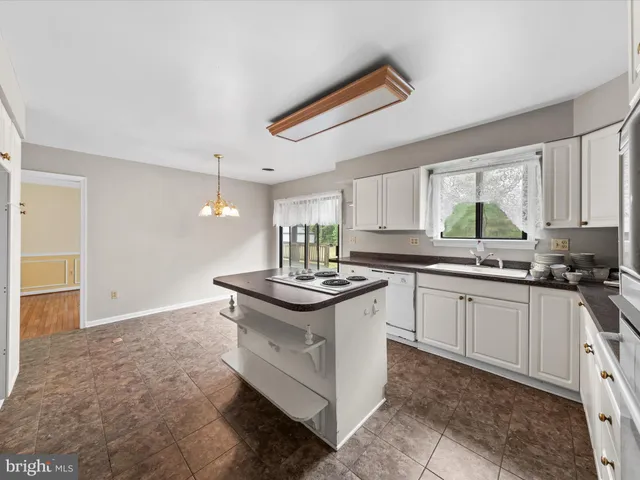 a kitchen with stainless steel appliances granite countertop a sink and a stove