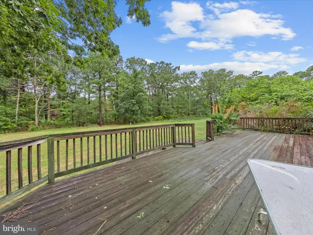 a view of balcony with wooden floor and fence