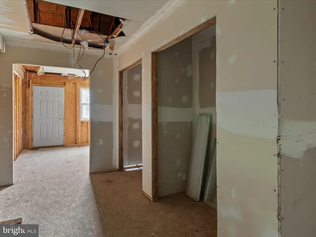 a view of a hallway with a glass door and a hallway