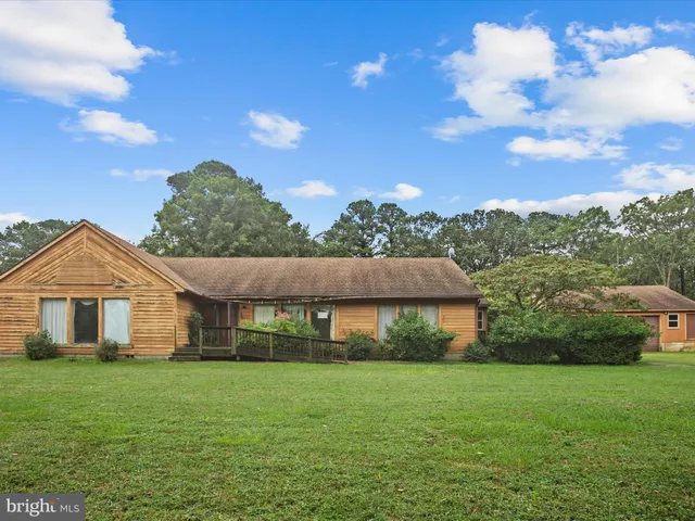 a view of an house with backyard space and balcony