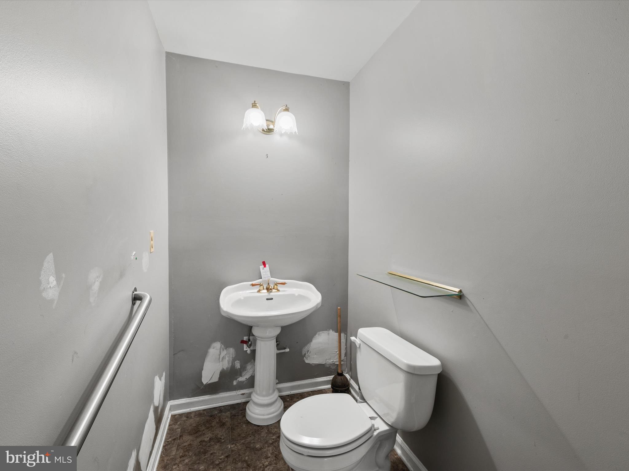 935 Susquehanna Road Madison, MD 21648 - Photo 9 of 42 a white toilet sitting next to a bathroom sink