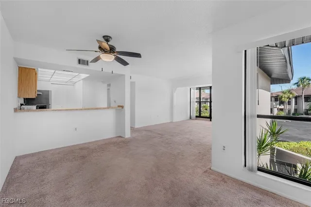 a view of livingroom with furniture and ceiling fan