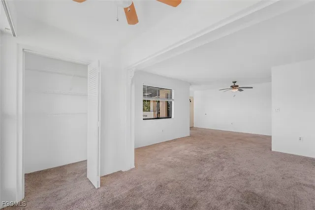 an empty room with a ceiling fan
