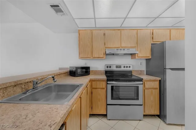 a kitchen with a sink stove and refrigerator