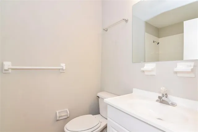 a white toilet sitting next to a bathroom sink