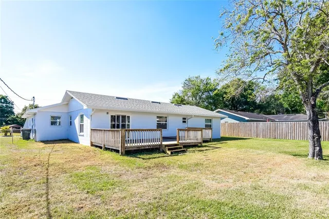 a view of a house with a yard and sitting area