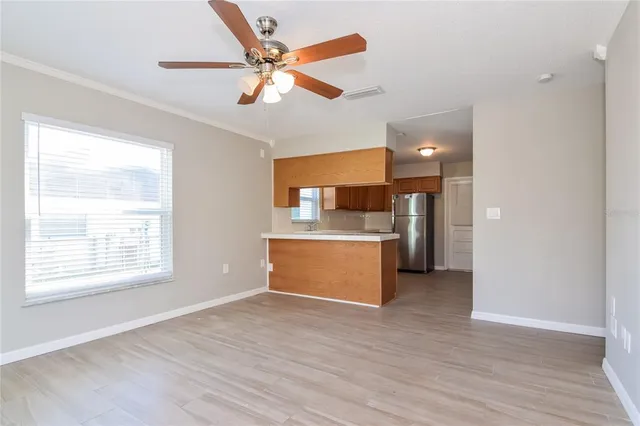 a view of kitchen with granite countertop cabinets and window