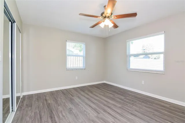 wooden floor in an empty room with a window