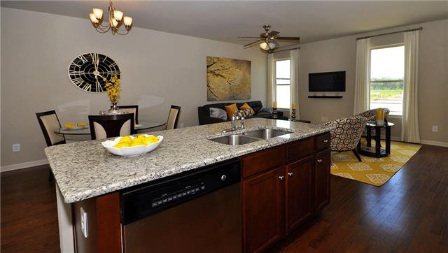 3937 Cannonsgate Lane Murfreesboro, TN 37128 - Photo 4 of 8 a kitchen with a granite counter top a stove and a dining table
