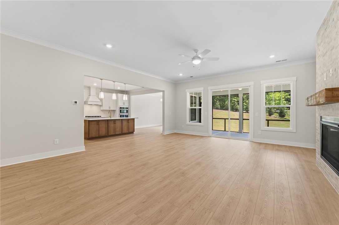 203 Timothy Court Anderson, SC 29621 - Photo 40 of 40 An open floor plan with hardwood floors transitions smoothly from the kitchen to a spacious living area with outdoor access.