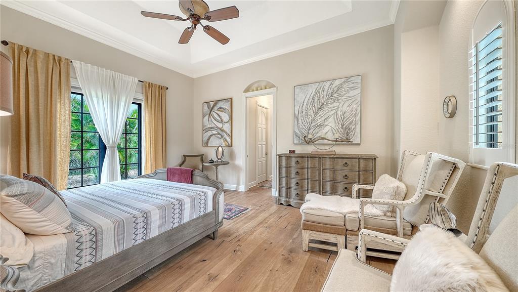 1630 Assisi Drive, Unit 18 Sarasota, FL 34231 - Photo 14 of 42 a bedroom with a bed and glass windows