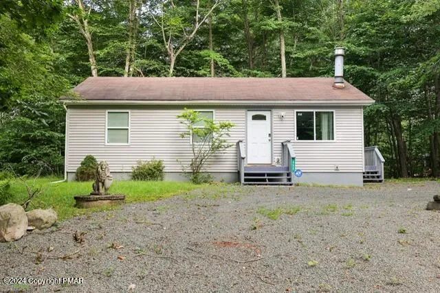 a backyard of a house with table and chairs