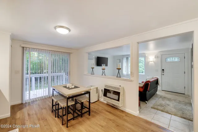a living room with furniture a fireplace and a table