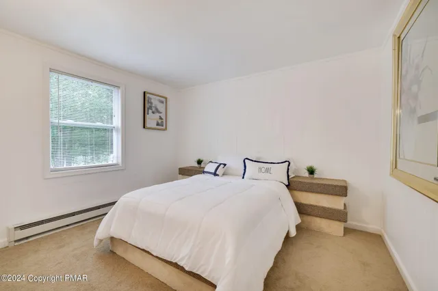 a bedroom with a bed and window