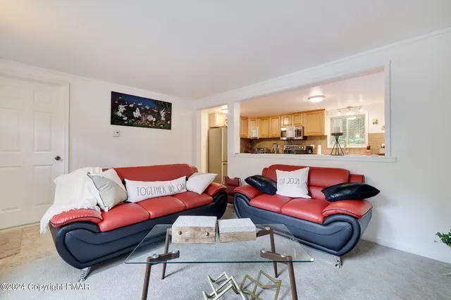 a living room with furniture and a rug