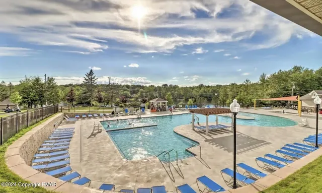 a view of a swimming pool with seating space