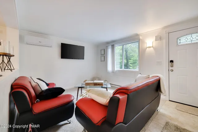 a bedroom with furniture and a flat screen tv