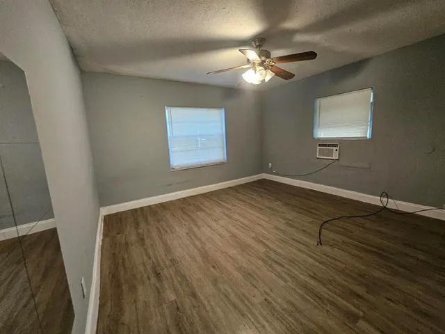 a view of a room with wooden floor and fan