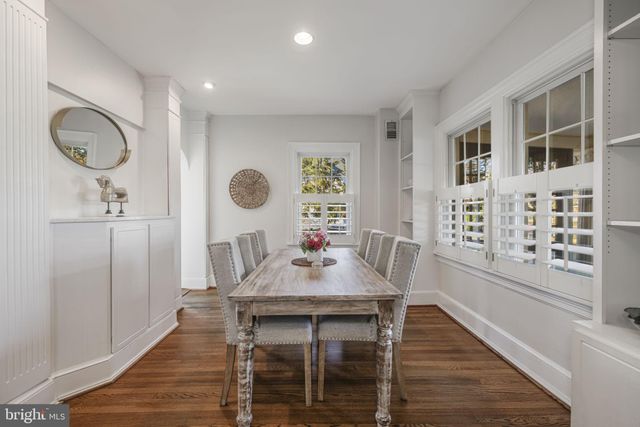 a view of a dining room with furniture wooden floor and a chandelier
