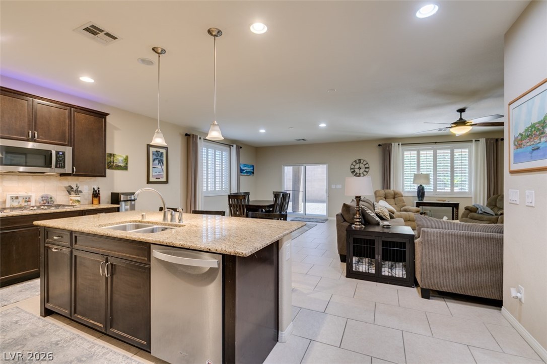7375 Campbell Ranch Avenue Las Vegas, NV 89179 - Photo 8 of 45 An open concept design seamlessly connects the culinary space with a cozy great room area.