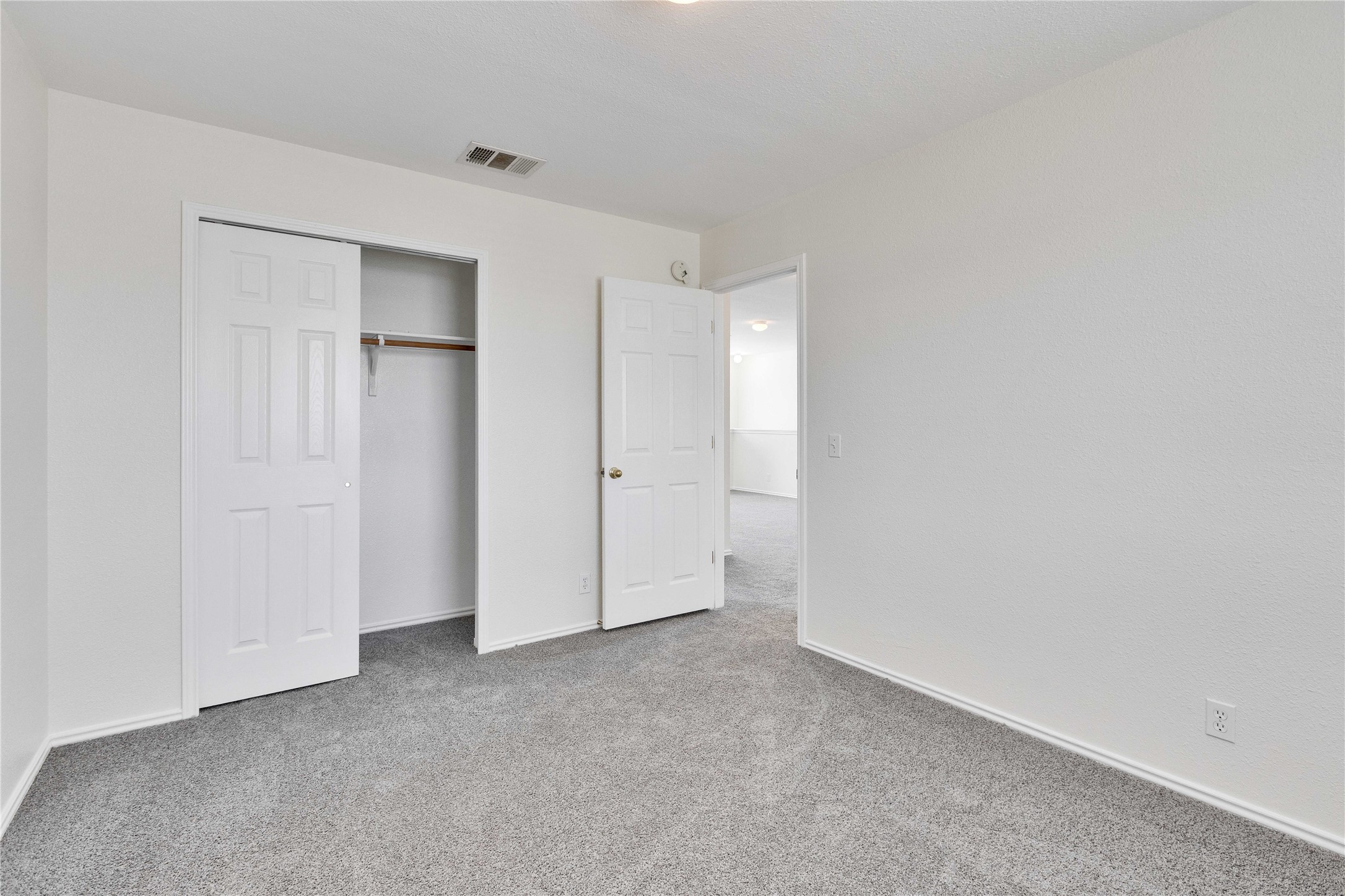 14418 Pebble Run Path Manor, TX 78653 - Photo 20 of 27 A well-maintained bedroom offers comfort and a dedicated closet for storage.