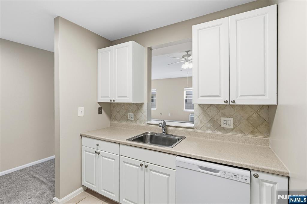 905 River Road, Unit 218 Edgewater, NJ 07020 - Photo 11 of 23 a kitchen with stainless steel appliances granite countertop a sink and a white cabinets