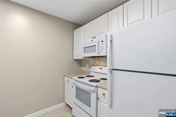a kitchen with cabinets and a stove